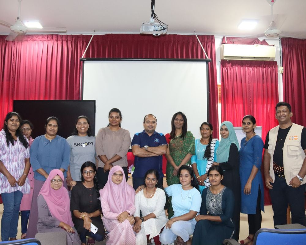 Dr. A. Lathaharan and Dr. Darshini with recently graduated midwives who received appointments